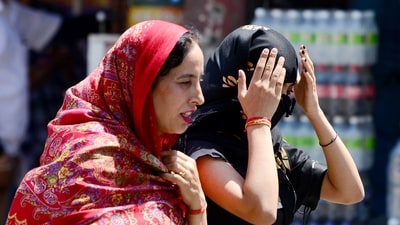 Women cover themselves to protect from the sun on a hot summer day (ANI) Women cover themselves to protect from the sun on a hot summer day (ANI)