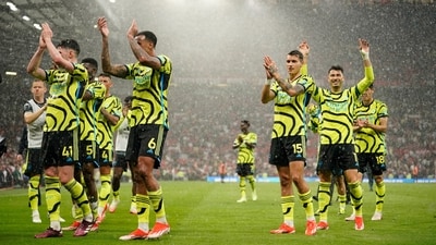 Arsenal's players celebrate after winning the English Premier League match against Manchester United. (AP)