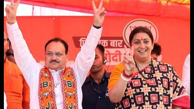 Bharatiya Janata Party (BJP) National President JP Nadda and party candidate from Amethi constituency Smriti Irani show victory signs during a public meeting for the Lok Sabha polls, in Amethi on Tuesday. (ANI) Bharatiya Janata Party (BJP) National President JP Nadda and party candidate from Amethi constituency Smriti Irani show victory signs during a public meeting for the Lok Sabha polls, in Amethi on Tuesday. (ANI)