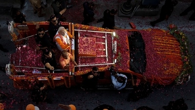Prime Minister Narendra Modi and UP chief minister Yogi Adityanath wave towards their supporters during a roadshow as part of an election campaign, in Varanasi, India, May 13. (REUTERS/Adnan Abidi)