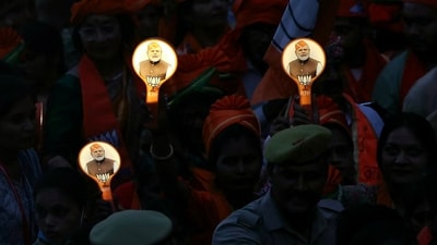 Supporters of Bharatiya Janata Party (BJP) holding campaign materials with pictures of India's Prime Minister Narendra Modi take part in a roadshow, in Varanasi on May 13. ((Photo by Niharika KULKARNI / AFP)) Supporters of Bharatiya Janata Party (BJP) holding campaign materials with pictures of India's Prime Minister Narendra Modi take part in a roadshow, in Varanasi on May 13. ((Photo by Niharika KULKARNI / AFP))