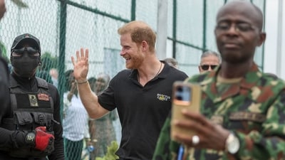 Britain's Prince Harry (C), Duke of Sussex, waves to the crowd as he arrives with Britain's Meghan (unseen), Duchess of Sussex, for an exhibition sitting volleyball match at Nigeria Unconquered, a local charity organisation that supports wounded, injured, or sick servicemembers, in Abuja on May 11, 2024 as they visit Nigeria as part of celebrations of Invictus Games anniversary. (Photo by Kola SULAIMON / AFP) (AFP) Britain's Prince Harry (C), Duke of Sussex, waves to the crowd as he arrives with Britain's Meghan (unseen), Duchess of Sussex, for an exhibition sitting volleyball match at Nigeria Unconquered, a local charity organisation that supports wounded, injured, or sick servicemembers, in Abuja on May 11, 2024 as they visit Nigeria as part of celebrations of Invictus Games anniversary. (Photo by Kola SULAIMON / AFP) (AFP)