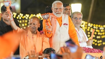 Prime Minister Narendra Modi with Uttar Pradesh chief minister Yogi Adityanath during a roadshow for the Lok Sabha elections in Varanasi on May 13. (PTI) Prime Minister Narendra Modi with Uttar Pradesh chief minister Yogi Adityanath during a roadshow for the Lok Sabha elections in Varanasi on May 13. (PTI)