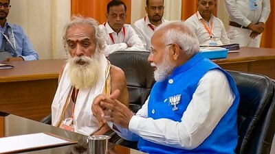 Prime Minister Narendra Modi with Pandit Ganeshwar Shastri while filing his nomination papers for Lok Sabha elections, in Varanasi, Tuesday. (PTI) Prime Minister Narendra Modi with Pandit Ganeshwar Shastri while filing his nomination papers for Lok Sabha elections, in Varanasi, Tuesday. (PTI)