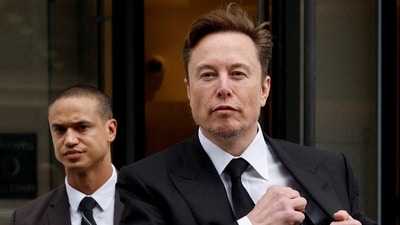 Tesla CEO Elon Musk and his security detail depart the company's local office in Washington, US. (Reuters)