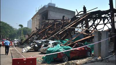 an under-construction metal parking lift collapsed in Wadala amid the dust storm on Monday. Three people were injured, and around eighteen vehicles were damaged in the collapse. (Bhushan Koyande/HT Photo)