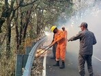 NDRF personnel try to control a fire that broke out in the forest of Pauri Garhwal district on Tuesday, May 14, 2024.