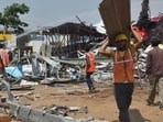 Workers remove debris at the accident site in Ghatkopar, Mumbai on Tuesday. (Praful Gangurde/HT Photo)