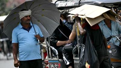 A man takes shelter under an umbrella from the scorching sun on a hot summer afternoon in New Delhi on May 3, 2024, amid the ongoing heatwave. (AFP) A man takes shelter under an umbrella from the scorching sun on a hot summer afternoon in New Delhi on May 3, 2024, amid the ongoing heatwave. (AFP)