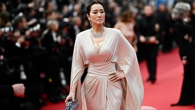 Cannes 2024: Chinese actress Gong Li arrives for the Opening Ceremony of the Cannes Film Festival. She also attended the screening of The Second Act. She chose a champagne-coloured wrap gown for the occasion. (AFP) Cannes 2024: Chinese actress Gong Li arrives for the Opening Ceremony of the Cannes Film Festival. She also attended the screening of The Second Act. She chose a champagne-coloured wrap gown for the occasion. (AFP)