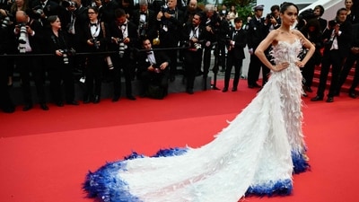 Cannes 2024: Indonesian actress, singer and model Cinta Laura Kiehl chose a cascading strapless gown for her red carpet appearance on Day 1. Her dress comes adorned in white and blue feathers, with the long train stealing the show. (AFP) Cannes 2024: Indonesian actress, singer and model Cinta Laura Kiehl chose a cascading strapless gown for her red carpet appearance on Day 1. Her dress comes adorned in white and blue feathers, with the long train stealing the show. (AFP)