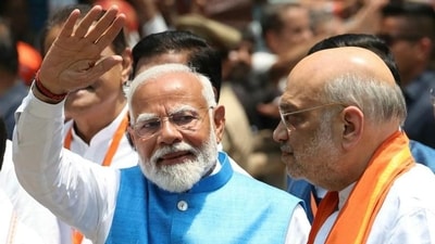 Prime Minister Narendra Modi waving to supporters as Union home minister Amit Shah looks on. (AFP file photo) Prime Minister Narendra Modi waving to supporters as Union home minister Amit Shah looks on. (AFP file photo)