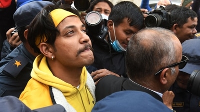 Nepali former national cricket captain Sandeep Lamichhane (L) is escorted by police outside the districtl court following his release on bail after three months in custody for sexual assault charges, (AFP) Nepali former national cricket captain Sandeep Lamichhane (L) is escorted by police outside the districtl court following his release on bail after three months in custody for sexual assault charges, (AFP)