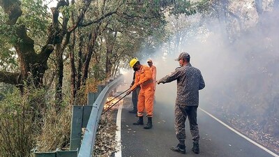 NDRF personnel try to control a fire that broke out in the forest of Pauri Garhwal district on Tuesday, May 14, 2024. (PTI) NDRF personnel try to control a fire that broke out in the forest of Pauri Garhwal district on Tuesday, May 14, 2024. (PTI)