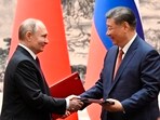 Chinese President Xi Jinping, right, and Russian President Vladimir Putin exchange documents after a signing ceremony during their meeting in Beijing, China. (AP) Chinese President Xi Jinping, right, and Russian President Vladimir Putin exchange documents after a signing ceremony during their meeting in Beijing, China. (AP)