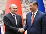 Russian President Vladimir Putin shakes hands with Chinese President Xi Jinping during a meeting in Beijing.
