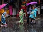 School children wearing raincoats walk during a heavy downpour after a spell of heatwave in Kolkata, India, Thursday, May 9, 2024.