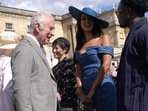 King Charles speaks with Maya Jama and Campbell Addy.
King Charles speaks with Maya Jama and Campbell Addy.