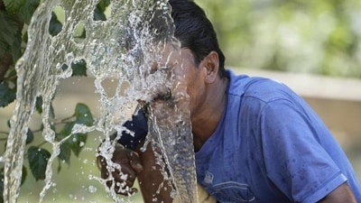 A person splashes water on his face from an irrigation pipe to beat the intense heat wave in Lucknow. (File Photo/AP) A person splashes water on his face from an irrigation pipe to beat the intense heat wave in Lucknow. (File Photo/AP)