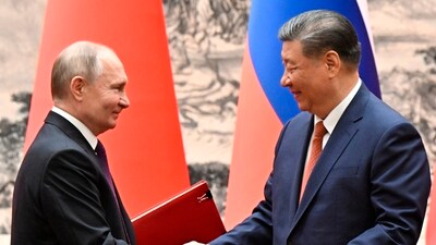 Chinese President Xi Jinping, right, and Russian President Vladimir Putin exchange documents after a signing ceremony during their meeting in Beijing, China. (AP) Chinese President Xi Jinping, right, and Russian President Vladimir Putin exchange documents after a signing ceremony during their meeting in Beijing, China. (AP)