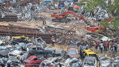 At the site, mangled remains of 47 two wheelers, 39 four wheelers, and 10 rickshaws – crushed under the weight of the hoarding – lay in heaps. The asphalt tanker that had saved the lives of 12 people who took refuge under it was yet to be evacuated as well due to the scorching temperatures of the bitumen inside. (Satish Bate/ Hindustan Times)