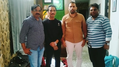 Bhavesh Bhinde (in black) was apprehended at a hotel in Udaipur