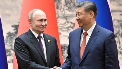 Russian President Vladimir Putin shakes hands with Chinese President Xi Jinping during a meeting in Beijing. (via REUTERS)