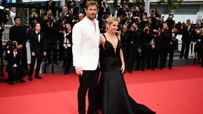 Chris Hemsworth was joined by his wife Elsa Pataky on the red carpet at the Cannes Film Festival. Chris kept his look understated in a white open-button shirt, matching blazer and black trousers combo. On the other hand, Elsa Pataky dazzled in a black plunging gown from the Armani Privé Spring 2005 collection. (Photo by CHRISTOPHE SIMON / AFP) Chris Hemsworth was joined by his wife Elsa Pataky on the red carpet at the Cannes Film Festival. Chris kept his look understated in a white open-button shirt, matching blazer and black trousers combo. On the other hand, Elsa Pataky dazzled in a black plunging gown from the Armani Privé Spring 2005 collection. (Photo by CHRISTOPHE SIMON / AFP)