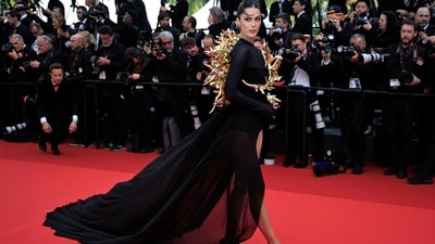 French model Iris Mittenaere was definitely one of the best-dressed stars as she turned heads in a gorgeous black gown. Her outfit featured sheer fabric, full sleeves, a striking side slit and a floor-length train at the back, all of which added to the drama. However, it was the golden thorn embellishment that caught the attention of fashion critics. (Photo by Valery HACHE / AFP) French model Iris Mittenaere was definitely one of the best-dressed stars as she turned heads in a gorgeous black gown. Her outfit featured sheer fabric, full sleeves, a striking side slit and a floor-length train at the back, all of which added to the drama. However, it was the golden thorn embellishment that caught the attention of fashion critics. (Photo by Valery HACHE / AFP)