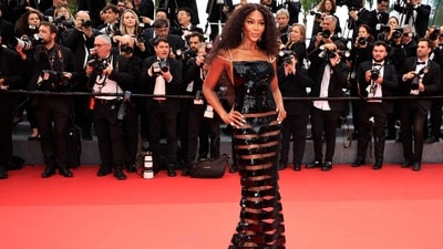 British model, actress and activist Naomi Campbell stunned on the red carpet in a vintage Chanel outfit. Her head-turning look features a black dress that comes with delicate pearl straps, plunging sides, straight-across neckline and bands of sheer panels on the bottom peeking out from between the sequins. She completed the look with sleek black pumps and wore her hair in huge curls. (Valery HACHE / AFP) British model, actress and activist Naomi Campbell stunned on the red carpet in a vintage Chanel outfit. Her head-turning look features a black dress that comes with delicate pearl straps, plunging sides, straight-across neckline and bands of sheer panels on the bottom peeking out from between the sequins. She completed the look with sleek black pumps and wore her hair in huge curls. (Valery HACHE / AFP)