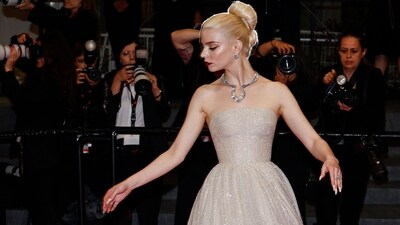 British-US actress Anya Taylor-Joy poses after the screening of the film "Furiosa: A Mad Max Saga" in a stunning shimmer gown. Her Dior outfit exudes sartorial elegance with its off-shoulder neckline and a flared bottom adorned with sparkle. Accessorised with jewels by Tiffany & Co and styled with a bun hairdo, she stole the spotlight. (Photo by Sameer Al-Doumy / AFP) British-US actress Anya Taylor-Joy poses after the screening of the film "Furiosa: A Mad Max Saga" in a stunning shimmer gown. Her Dior outfit exudes sartorial elegance with its off-shoulder neckline and a flared bottom adorned with sparkle. Accessorised with jewels by Tiffany & Co and styled with a bun hairdo, she stole the spotlight. (Photo by Sameer Al-Doumy / AFP)
