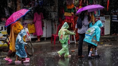 School children wearing raincoats walk during a heavy downpour after a spell of heatwave in Kolkata, India, Thursday, May 9, 2024. (AP) School children wearing raincoats walk during a heavy downpour after a spell of heatwave in Kolkata, India, Thursday, May 9, 2024. (AP)