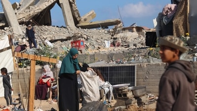 Displaced Palestinians pack their belongings before leaving an unsafe area in Rafah (AFP) Displaced Palestinians pack their belongings before leaving an unsafe area in Rafah (AFP)