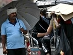 A man takes shelter under an umbrella from the scorching sun on a hot summer afternoon in New Delhi A man takes shelter under an umbrella from the scorching sun on a hot summer afternoon in New Delhi