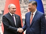 Russian President Vladimir Putin shakes hands with Chinese President Xi Jinping during a meeting in Beijing.
