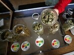  A volunteer displays jars of dried cannabis buds at the La Brea Collective medical marijuana dispensary in Los Angeles, California, March 18, 2014. REUTERS/Lucy Nicholson/File Photo