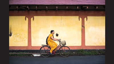 A seemingly “normal” girl cycling down a street in Kochi, Kerala. (Matthew Williams-Ellis/Universal via Getty Images) A seemingly “normal” girl cycling down a street in Kochi, Kerala. (Matthew Williams-Ellis/Universal via Getty Images)