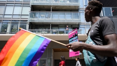 Onlookers watch as LGBTQ+ rights activists hold a rally (AFP) Onlookers watch as LGBTQ+ rights activists hold a rally (AFP)