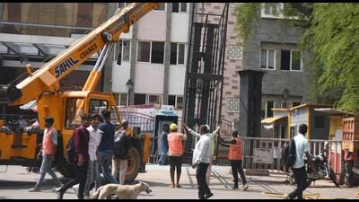 Civic staff pulling down the hoarding at Shivajinagar on Friday. (MAHENDRA KOLHE) Civic staff pulling down the hoarding at Shivajinagar on Friday. (MAHENDRA KOLHE)