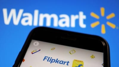 A mobile phone showing an image of Indian online retailer Flipkart is seen in front of a Walmart Inc logo displayed. (Reuters)