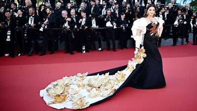 Aishwarya Rai took over the red carpet as she stunned in an exquisite floor-sweeping gown by Indian designer Falguni Shane Peacock. Her dress was a stunning combination of black and white, with a long train embellished with gold molten flowers adding a touch of drama. (Photo by LOIC VENANCE / AFP) Aishwarya Rai took over the red carpet as she stunned in an exquisite floor-sweeping gown by Indian designer Falguni Shane Peacock. Her dress was a stunning combination of black and white, with a long train embellished with gold molten flowers adding a touch of drama. (Photo by LOIC VENANCE / AFP)