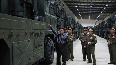 North Korea's leader Kim Jong Un (L) inspecting the missile launcher vehicles to be newly equipped by the combined missile units of the Korean People's Army (KPA) (AFP)