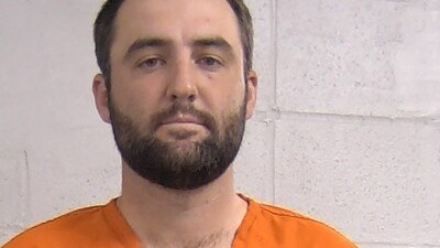 TOPSHOT - This May 17, 2024, booking photo obtained from the Louisville Department of Corrections shows golfer Scottie Scheffler. Golf world number one, Scheffler, was handcuffed and taken into custody by police early on May 17, according to video footage and media reports, after allegedly trying to drive around traffic controls outside the PGA Championship at Valhalla. Scheffler was detained by a Louisville Metro police officer when he attempted to drive around the scene of an accident to get into the golf course, where he was scheduled to compete in the second round of the major tournament Friday morning. (Photo by Handout / Louisville Department of Corrections / AFP) (AFP)