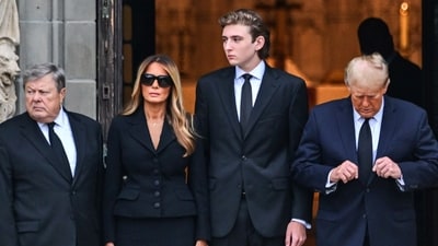 Former US President Donald Trump (R) stands with his wife Melania Trump (2L) their son Barron Trump (C) and father-in-law Viktor Knavs in Palm Beach, Florida. (AFP)