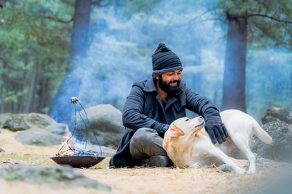Rakshit Shetty and Charlie have a playful moment in 777 Charlie. Rakshit Shetty and Charlie have a playful moment in 777 Charlie.