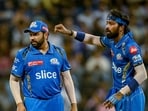 Mumbai Indians' captain Hardik Pandya (R) gestures as Rohit Sharma looks on during the Indian Premier League (IPL) Twenty20 cricket match between Mumbai Indians and Lucknow Super Giants