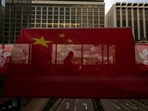 FILE- A pedestrian walks through a footbridge is silhouetted as Chinese and Hong Kong flags are strung to mark the 26th anniversary of the city's handover from Britain to China in Hong Kong, on June 27, 2023. Hong Kong’s plan to enact a new national security law, on top of a sweeping legislation that was imposed by Beijing and used to crack down on dissent, is deepening concerns over the erosion of freedoms in the former British colony.(AP Photo/Louise Delmotte, File) FILE- A pedestrian walks through a footbridge is silhouetted as Chinese and Hong Kong flags are strung to mark the 26th anniversary of the city's handover from Britain to China in Hong Kong, on June 27, 2023. Hong Kong’s plan to enact a new national security law, on top of a sweeping legislation that was imposed by Beijing and used to crack down on dissent, is deepening concerns over the erosion of freedoms in the former British colony.(AP Photo/Louise Delmotte, File)