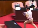 Taiwan parliamentarian snatches bill to halt passage. Taiwan parliamentarian snatches bill to halt passage.