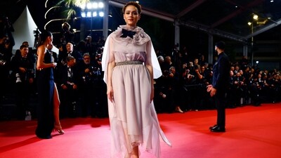 Nathalie Emmanuel looks ravishing on the red carpet in a pastel pink ensemble with a flowy silhouette and sequined belt at the waist. Teamed with a matching cape adorned with a black bow and ruffle embellishment, she looked stylish yet elegant. (REUTERS/Sarah Meyssonnier)