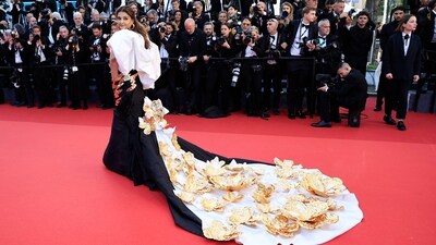 The former Miss World exuded elegance in a gown adorned with intricate golden patterns. Her attire featured a long train embellished with opulent golden flowers, exuding an aura of regal charm. (AFP) The former Miss World exuded elegance in a gown adorned with intricate golden patterns. Her attire featured a long train embellished with opulent golden flowers, exuding an aura of regal charm. (AFP)